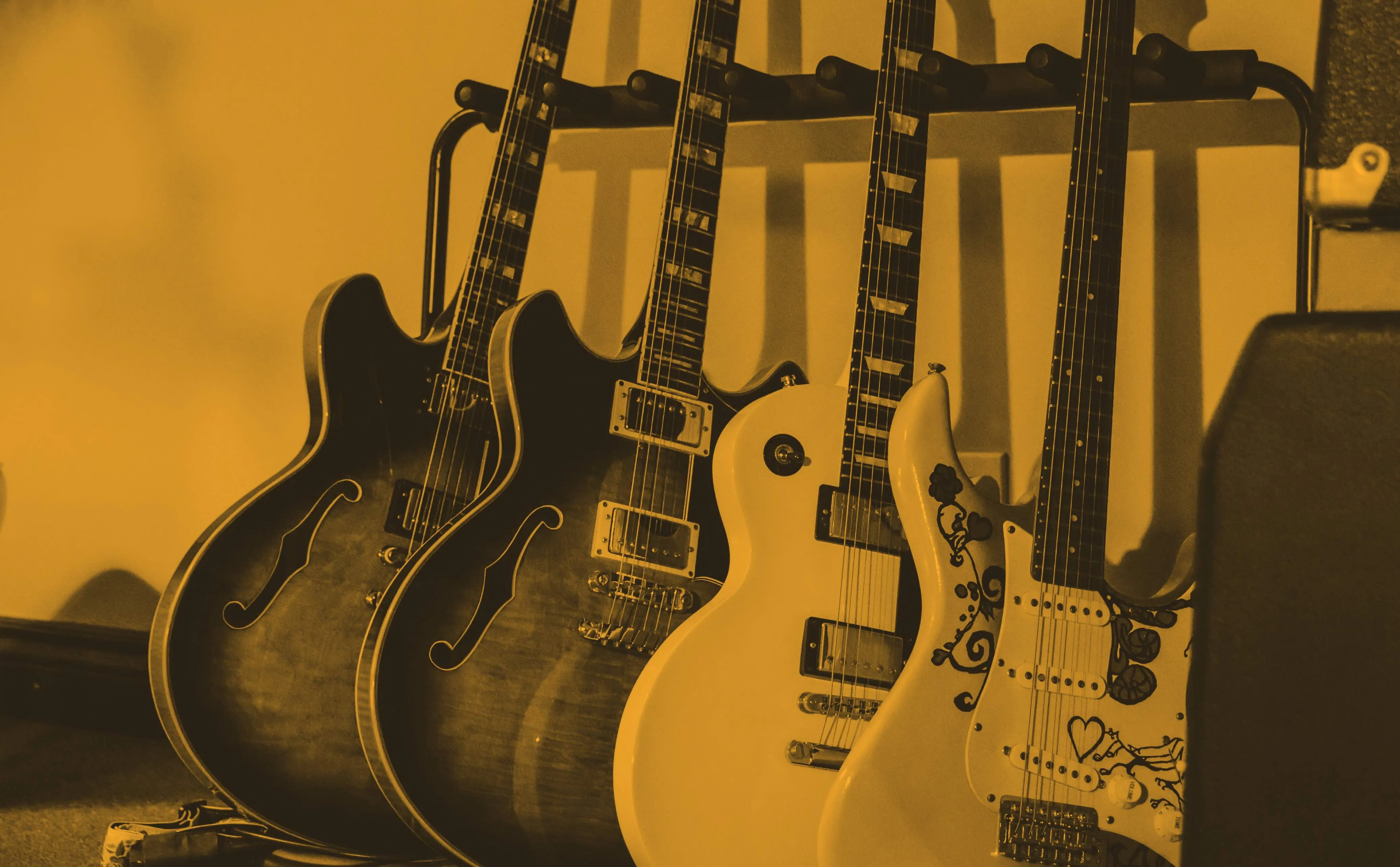 Collection of professional guitars including Gibson Les Paul, Fender Stratocaster, Ibanez AS200, Taylor Acoustic Guitar, and Fender Bass Guitar available for recording sessions at our Kingston, Ontario studio